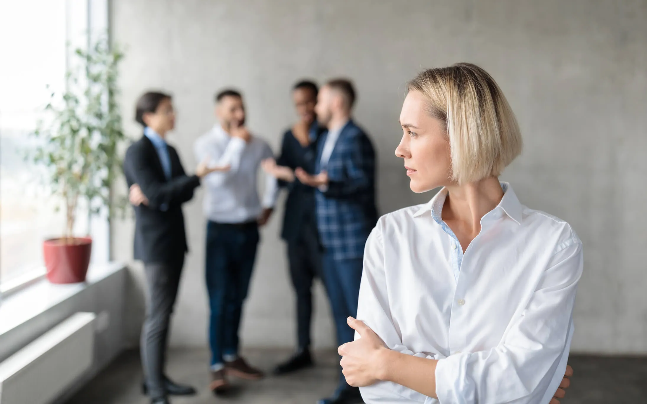 A woman isolated from her coworkers.
