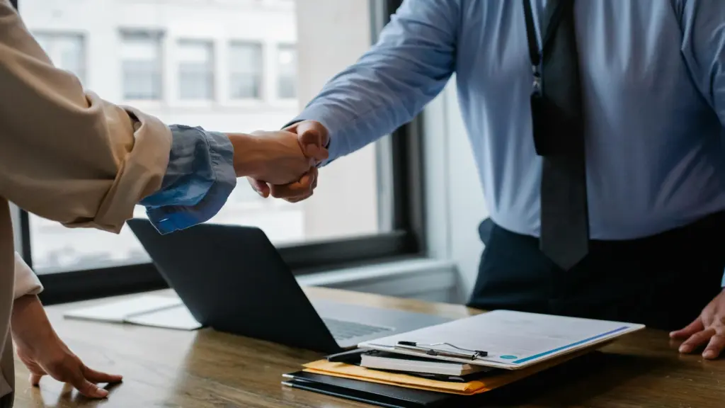 Employment attorney shaking hands with client.