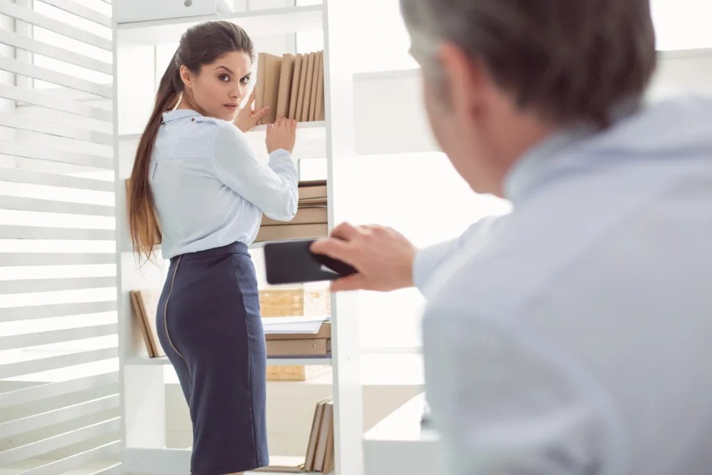 A man taking a picture of a woman at work.