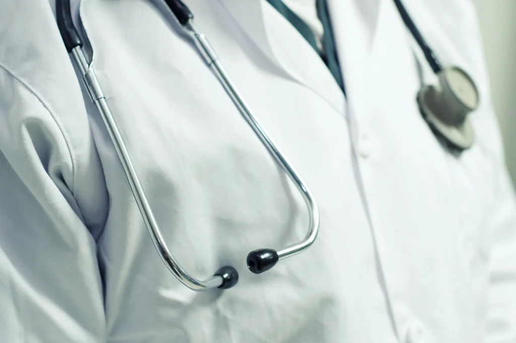 A doctor or nurse wearing a stethoscope 