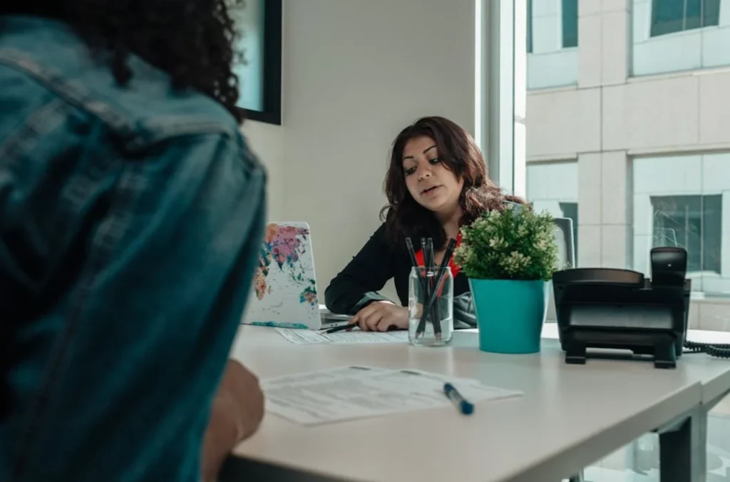 Two ladies sitting at a desk