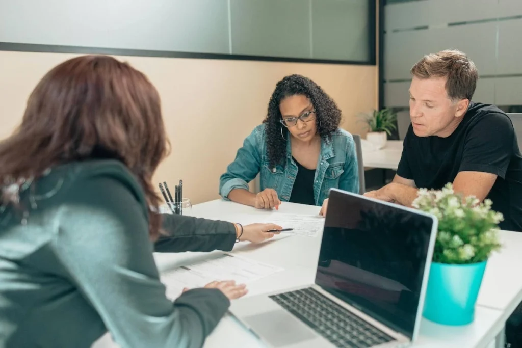 An attorney meeting with a couple at her desk